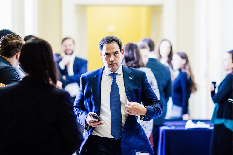 Sen. Marco Rubio adjusts the lapels of his suit jacket as he leaves a weekly policy luncheon with GOP lawmakers in April in Washington.